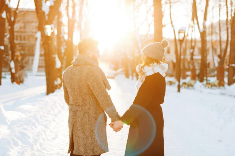 Romantic Getaways in Missouri, happy couple standing out in the snow